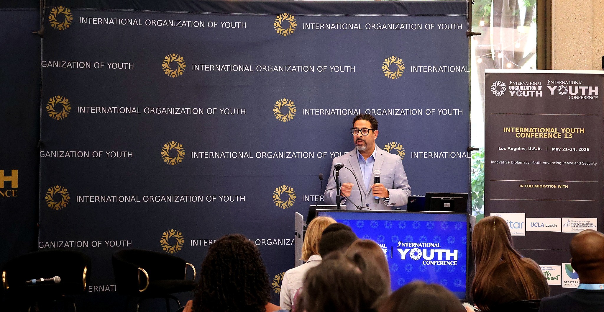 International Youth Conference speaker at podium
